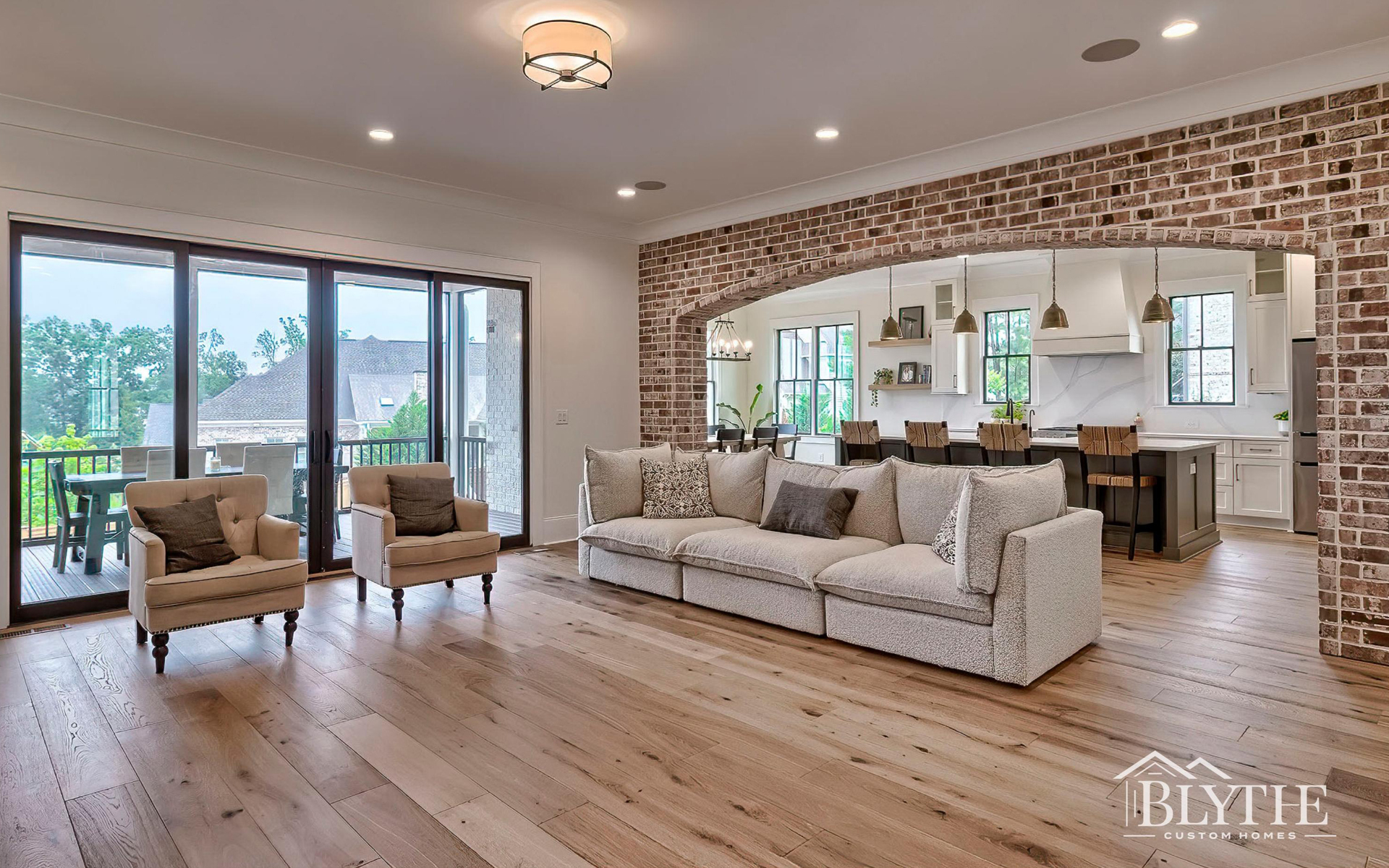 Blythe Custom Homes' Brick Archway Between Great Room & Kitchen