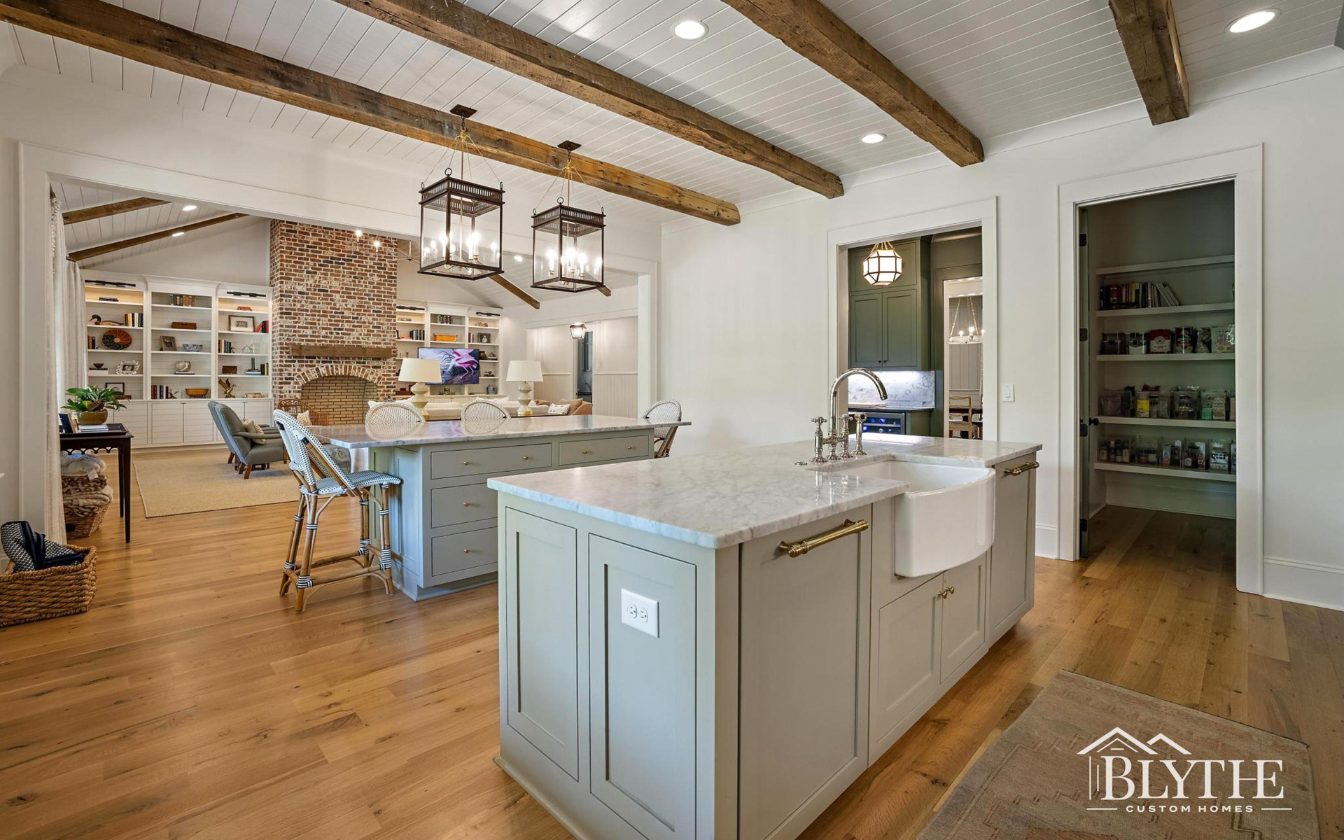 Blythe Custom Homes' Double Kitchen Islands with Fireplace View