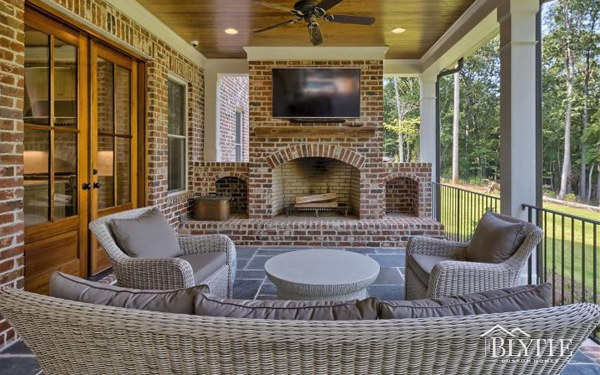 Blythe Custom Homes' Outdoor Fireplace on Large Back Porch
